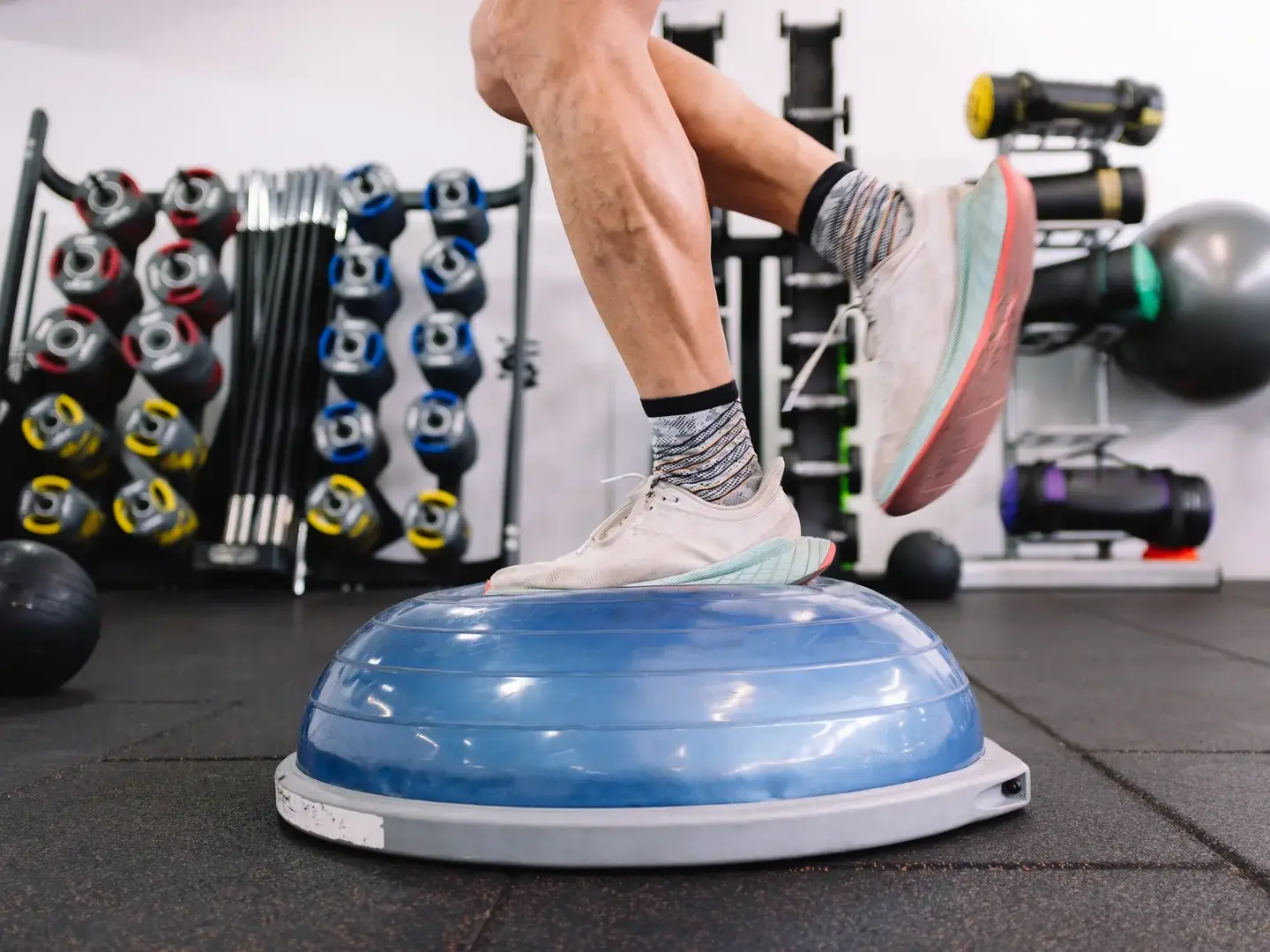 An adult performing an exercise on a balance trainer