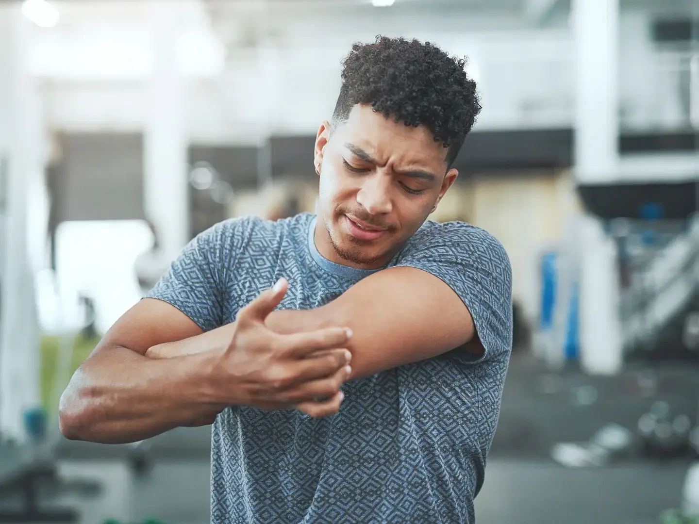 An adult holding a sore elbow
