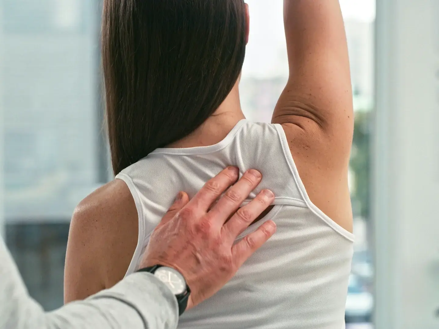 A clinician assessing a patient’s shoulder movement