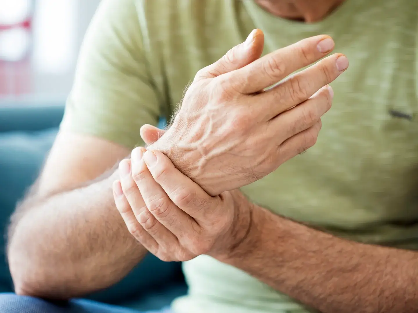 An adult holding their wrist